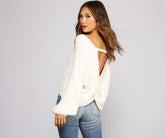 Suéter acogedor con nudo en la espalda