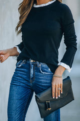 Suéter de punto negro con dobladillo blanco de As It Happens