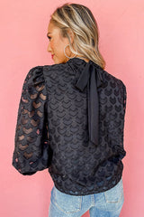 Top negro con mangas llamativas y lazo en la espalda No Secrets