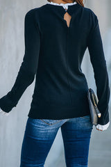 Suéter de punto negro con dobladillo blanco de As It Happens