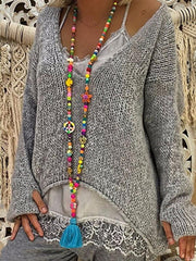 Suéter de punto irregular de manga larga con cuello en V y guantes de talla grande